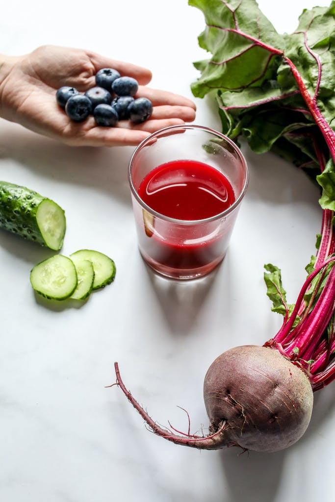 Juicing fresh vegetables into a glass.