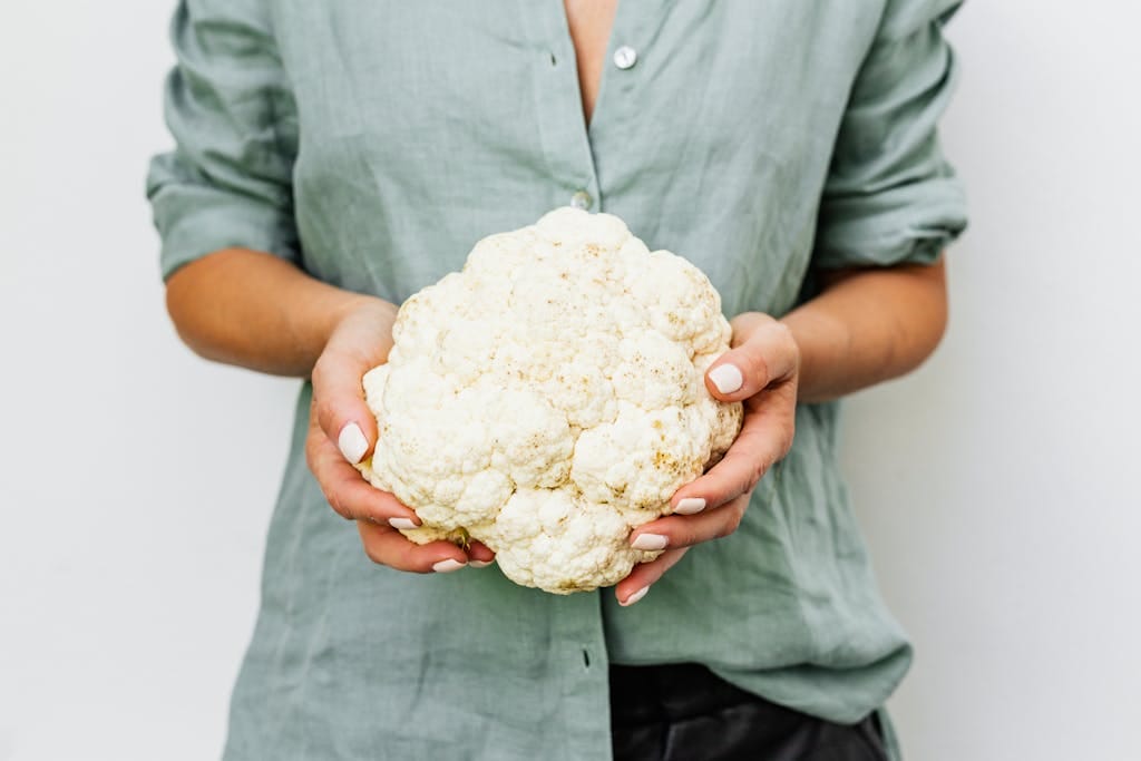 White cauliflower in container vs. wilted brown-spotted cauliflower.