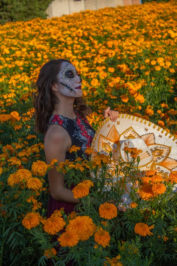 Woman in Marigolds Field Wearing Day of the Dead Makeup